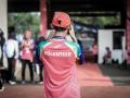 The back of someone wearing a red 'Volunteer' shirt