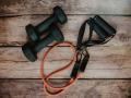 Black and orange workout equipment on top of wood slats