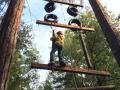 A person completing a ropes course 
