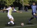 Student kicking a soccer ball 
