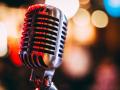 A microphone in front of a multi-colored bokeh background