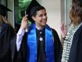 Happy male grad adjusts the tassel on his cap