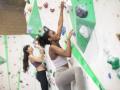 Two people climbing on an indoor rock climbing wall 