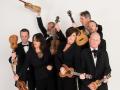 The members of the Ukulele Orchestra of Great Britain posing with their ukeleles