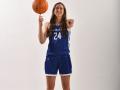 Sonoma State Women's Basketball player Keara Colombo holding a basketball and pointing at the camera