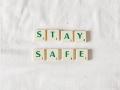 Scrabble pieces arranged to spell out "Stay Safe" 