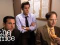 An image from the show 'The Office' of three men sitting in business attire 