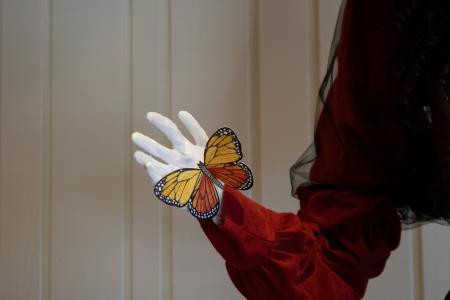 Skeleton hand holding butterfly 