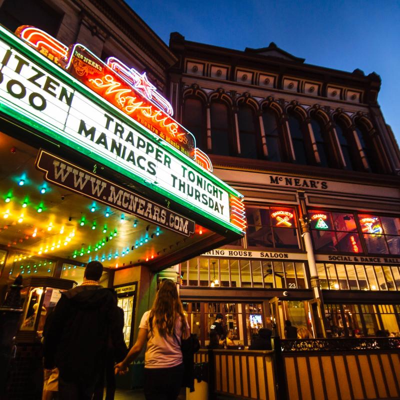 Mysitc Theater exterior shot with two people walking into the venue