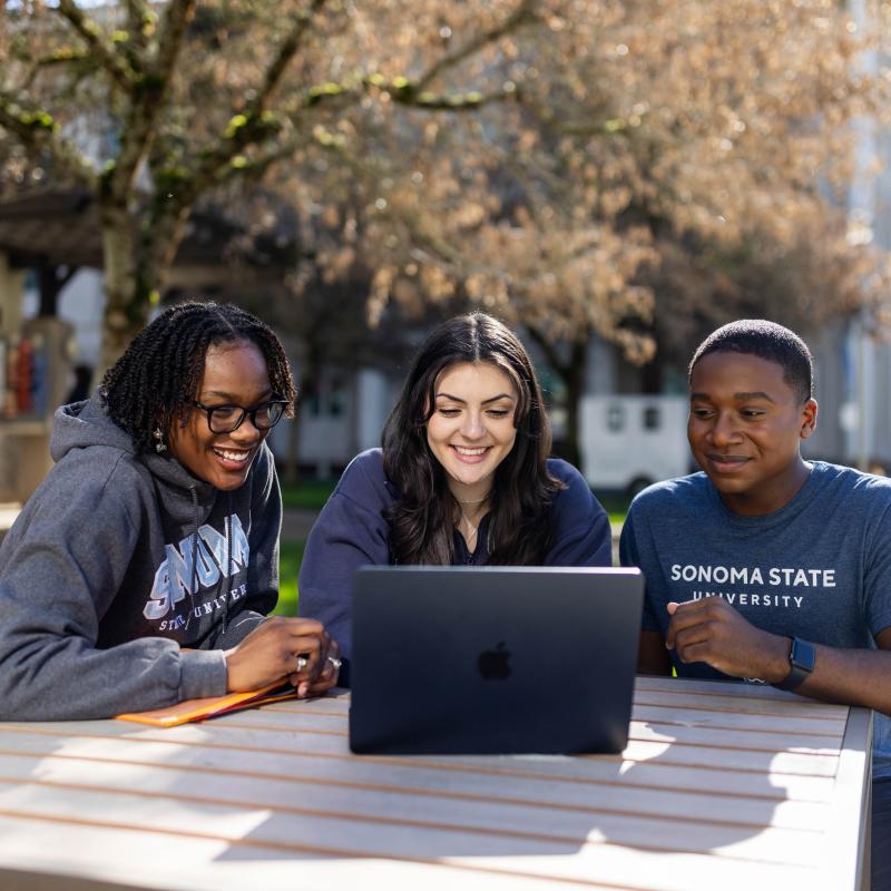 Three students on a computer